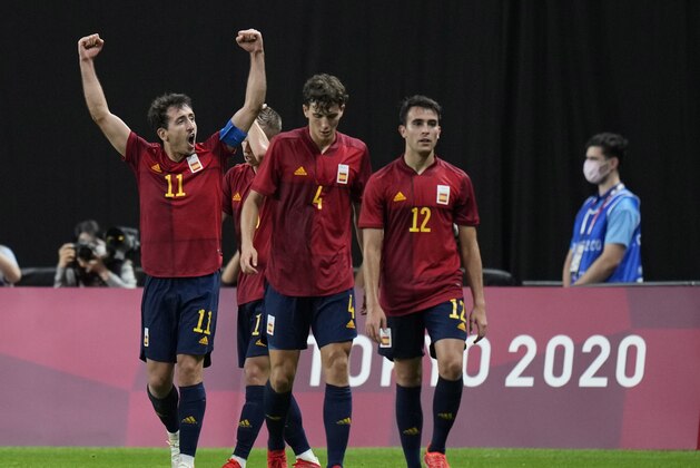 Spain's Mikel Oyarzabal, left, raises his arms in jubilation after scoring his side's first goal against Australia during a men's soccer match at the 2020 Summer Olympics, Sunday, July 25, 2021, in Sapporo, Sapporo, Japan. (AP Photo/Silvia Izquierdo)