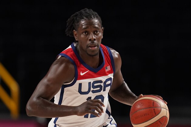 United States' Jrue Holiday (12) drives to the basket during men's basketball preliminary round game against Iran at the 2020 Summer Olympics, Wednesday, July 28, 2021, in Saitama, Japan. (AP Photo/Charlie Neibergall)