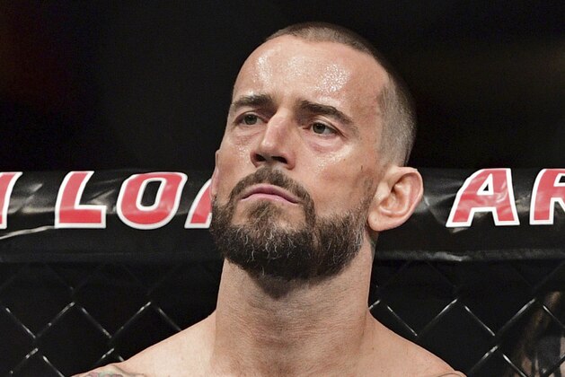 FILE - In this Sept. 10, 2016, file photo, CM Punk stands in his corner before a welterweight bout at UFC 203 in Cleveland. Punk went 0-2 in UFC and has given himself until the new year to decide if he wants to keep fighting. Punk hopes to stick in the sport as a mixed martial arts announcer. (AP Photo/David Dermer, File)