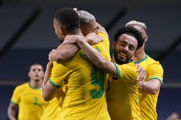 Brazil's Matheus Cunha, 9, celebrates scoring the opening goal against Egypt with teammates during a men's quarterfinal soccer match at the 2020 Summer Olympics, Saturday, July 31, 2021, in Saitama, Japan. (AP Photo/Martin Mejia)