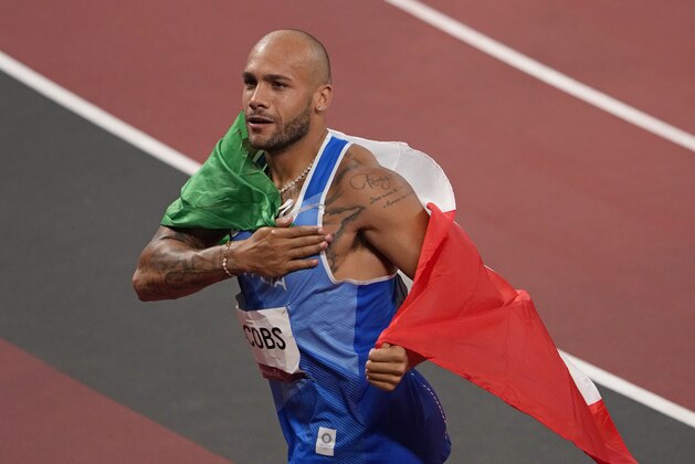 Lamont Marcell Jacobs, of Italy celebrates after winning the gold medal in the final of the men's 100-meters at the 2020 Summer Olympics, Sunday, Aug. 1, 2021, in Tokyo, Japan. (AP Photo/Charlie Riedel)