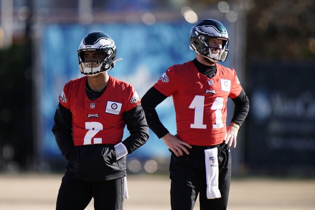 Philadelphia Eagles' Jalen Hurts, left, and Carson Wentz watch a drill during practice at the NFL football team's training facility, Thursday, Dec. 10, 2020, in Philadelphia. (AP Photo/Matt Slocum, Pool)