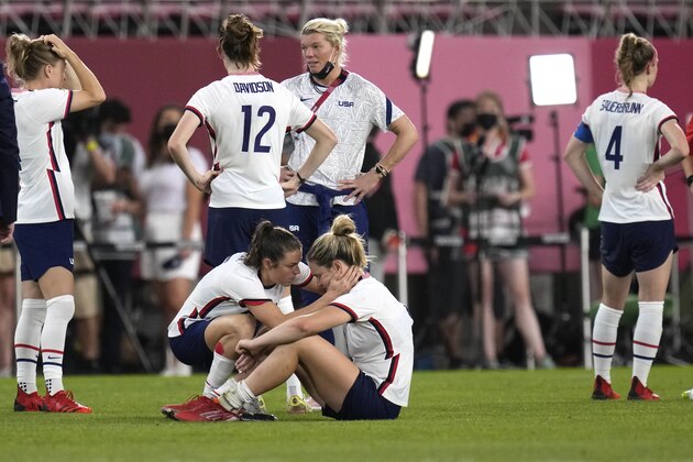 United States' Kelley O'Hara, left, talks to teammate Lindsey Horan after being defeated 1-0 by Canada during a women's semifinal soccer match at the 2020 Summer Olympics, Monday, Aug. 2, 2021, in Kashima, Japan.(AP Photo/Andre Penner)