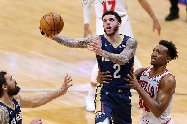 New Orleans Pelicans' Lonzo Ball, left, and Chicago Bulls' Zach LaVine greet one another after an NBA basketball game Wednesday, Feb. 10, 2021, in Chicago. (AP Photo/Charles Rex Arbogast)