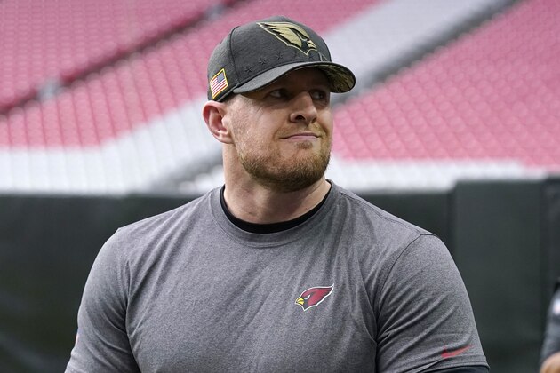 An injured Arizona Cardinals defensive end J.J. Watt smiles at cheering fans during NFL football training camp practice, Saturday, July 31, 2021, in Glendale, Ariz. (AP Photo/Ross D. Franklin)