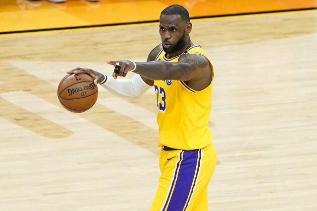 Los Angeles Lakers forward LeBron James (23) calls a play during the first half of Game 5 of an NBA basketball first-round playoff series against the Phoenix Suns, Tuesday, June 1, 2021, in Phoenix. (AP Photo/Matt York)