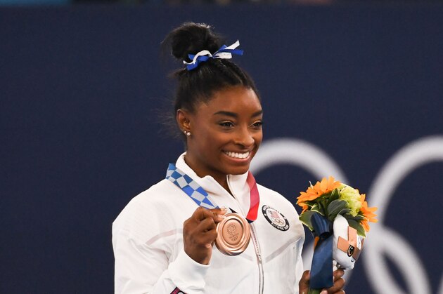 Simone Biles of Team United States, holds her bronze medal during the victory ceremony of the balance beam final at the Tokyo 2020 Olympic Games at the Ariake Gymnastics Centre in Tokyo, Japan, on Tuesday, Aug. 3, 2021. Biles returned to competition after she previously withdrew from the individual all-around final competition and the women's gymnastics team final to focus on her mental health. Photographer: Noriko Hayashi/Bloomberg via Getty Images