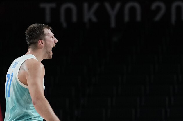 Slovenia's Luka Doncic (77) celebrates score during men's basketball quarterfinal game against Germany at the 2020 Summer Olympics, Tuesday, Aug. 3, 2021, in Saitama, Japan. (AP Photo/Eric Gay)