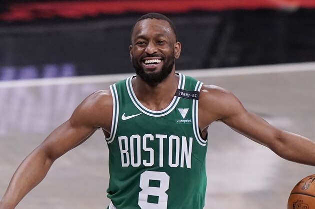 Boston Celtics guard Kemba Walker (8) laughs as he takes the ball up court during the second quarter of Game 2 of an NBA basketball first-round playoff series against the Brooklyn Nets, Tuesday, May 25, 2021, in New York. (AP Photo/Kathy Willens)