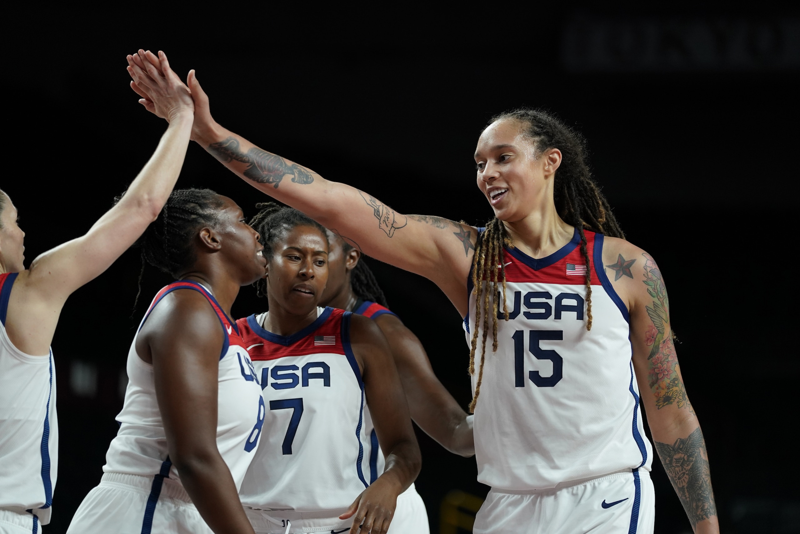 United States' Brittney Griner (15), right, celebrates with teammates after making a basket during women's basketball semifinal game against Serbia at the 2020 Summer Olympics, Friday, Aug. 6, 2021, in Saitama, Japan. (AP Photo/Charlie Neibergall)