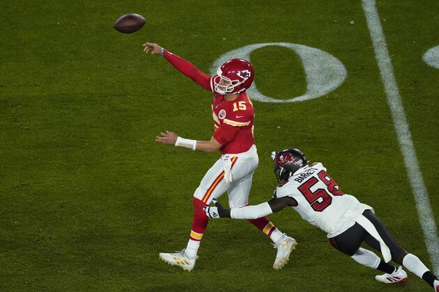 Kansas City Chiefs quarterback Patrick Mahomes (15) throws while being pressured by Tampa Bay Buccaneers' Shaquil Barrett (58) during the second half of the NFL Super Bowl 55 football game Sunday, Feb. 7, 2021, in Tampa, Fla. (AP Photo/Charlie Riedel)