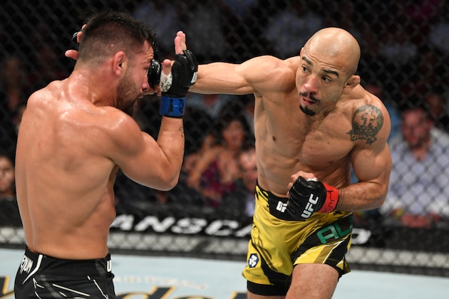 HOUSTON, TEXAS - AUGUST 07: (R-L) Jose Aldo of Brazil punches Pedro Munhoz of Brazil in their bantamweight bout during the UFC 265 event at Toyota Center on August 07, 2021 in Houston, Texas. (Photo by Josh Hedges/Zuffa LLC)