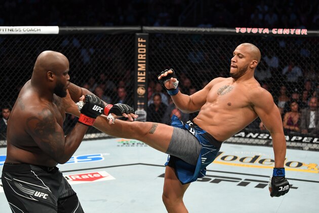 HOUSTON, TEXAS - AUGUST 07: (R-L) Ciryl Gane of France kicks Derrick Lewis in their interim heavyweight title bout during the UFC 265 event at Toyota Center on August 07, 2021 in Houston, Texas. (Photo by Josh Hedges/Zuffa LLC)