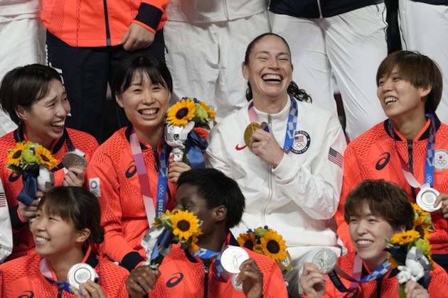 United States's Sue Bird, third right, poses with Japan players during the medal ceremony for women's basketball at the 2020 Summer Olympics, Sunday, Aug. 8, 2021, in Saitama, Japan. (AP Photo/Eric Gay)