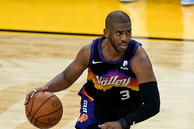 Phoenix Suns guard Chris Paul dribbles the ball against the Milwaukee Bucks during the second half of Game 2 of basketball's NBA Finals, Thursday, July 8, 2021, in Phoenix. The Suns defeated the Bucks 118-108. (AP Photo/Ross D. Franklin)