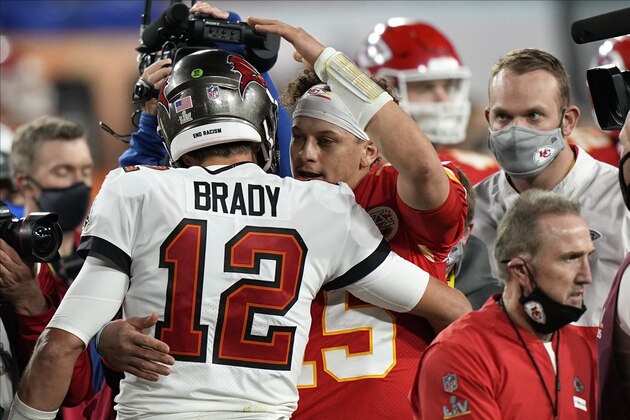 Tampa Bay Buccaneers quarterback Tom Brady embraces Kansas City Chiefs quarterback Patrick Mahomes after the NFL Super Bowl 55 football game, Sunday, Feb. 7, 2021, in Tampa, Fla. The Tampa Bay Buccaneers win 31-9. AP Photo/David J. Phillip)