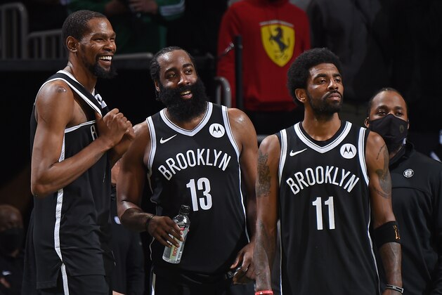 BOSTON, MA - MAY 30: Kevin Durant #7, James Harden #13 and Kyrie Irving #11 of the Brooklyn Nets smile during the game against the Boston Celtics during Round 1, Game 4 of the 2021 NBA Playoffs on May 30, 2021 at the TD Garden in Boston, Massachusetts.  NOTE TO USER: User expressly acknowledges and agrees that, by downloading and or using this photograph, User is consenting to the terms and conditions of the Getty Images License Agreement. Mandatory Copyright Notice: Copyright 2021 NBAE  (Photo by Brian Babineau/NBAE via Getty Images)