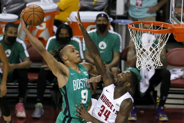 LAS VEGAS, NEVADA - AUGUST 10:  Romeo Langford #9 of the Boston Celtics dunks against Davon Reed #34 of the Denver Nuggets during the 2021 NBA Summer League at the Thomas & Mack Center on August 10, 2021 in Las Vegas, Nevada. NOTE TO USER: User expressly acknowledges and agrees that, by downloading and or using this photograph, User is consenting to the terms and conditions of the Getty Images License Agreement. (Photo by Ethan Miller/Getty Images)