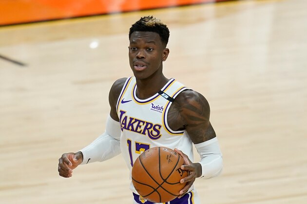 Los Angeles Lakers guard Dennis Schroder dribbles the ball against the Phoenix Suns during the first half of Game 1 of their NBA basketball first-round playoff series Sunday, May 23, 2021, in Phoenix. (AP Photo/Ross D. Franklin)