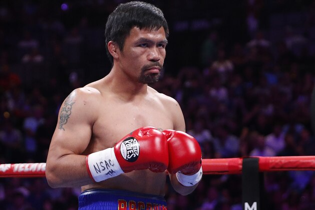 FILE - In this Saturday, July 20, 2019 file photo, Manny Pacquiao prepares to fight Keith Thurman in a welterweight title fight in Las Vegas. Qatar is preparing to host the 2022 World Cup and is now looking to attract big-name boxing. Promoter Bob Arum has been in talks with Qatari officials about bringing a welterweight unification bout between Manny Pacquiao and Terence Crawford to the energy-rich Gulf nation. (AP Photo/John Locher, File)