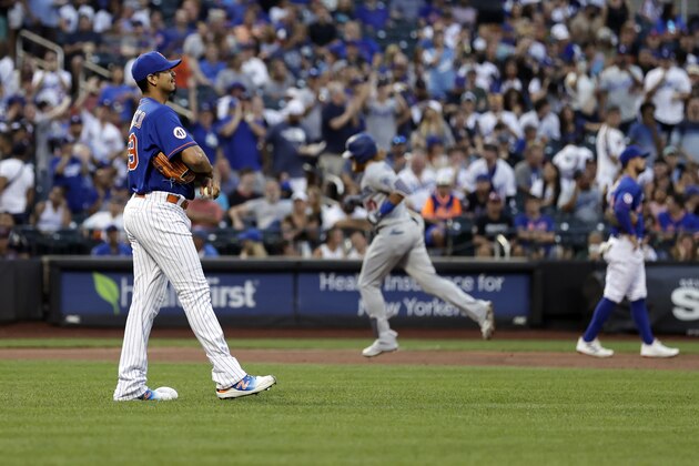 New York Mets pitcher Carlos Carrasco reacts after giving up a two-run home run to Los Angeles Dodgers' Justin Turner during the first inning of a baseball game on Sunday, Aug. 15, 2021, in New York. (AP Photo/Adam Hunger)