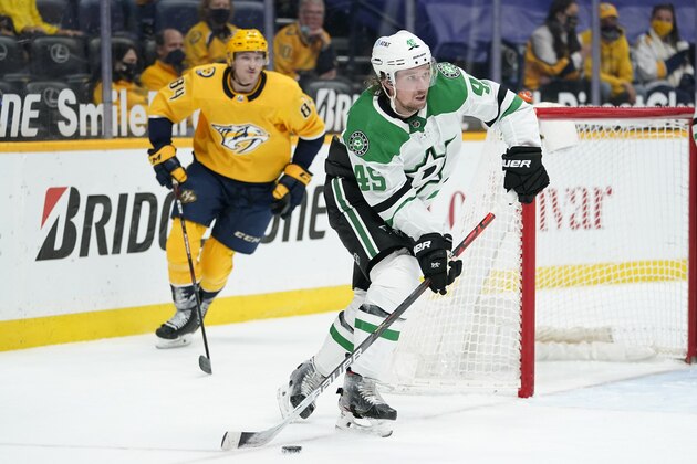 Dallas Stars defenseman Sami Vatanen (45) moves the puck ahead of Nashville Predators left wing Tanner Jeannot (84) in the second period of an NHL hockey game Saturday, May 1, 2021, in Nashville, Tenn. (AP Photo/Mark Humphrey)