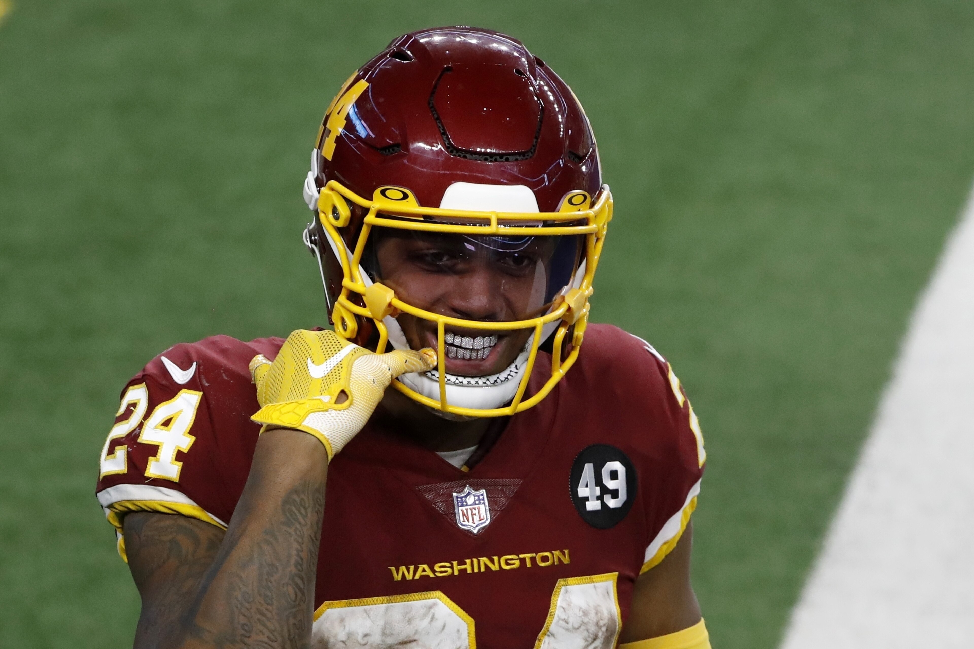 Washington Football Team running back Antonio Gibson (24) points to his mouth as he celebrates his touchdown in the second half of an NFL football game against the Dallas Cowboys in Arlington, Texas, Thursday, Nov. 26, 2020. (AP Photo/Roger Steinman) Washington Football Team running back Antonio Gibson (24) points to his mouth as he celebrates his touchdown in the second half of an NFL football game against the Dallas Cowboys in Arlington, Texas, Thursday, Nov. 26, 2020. (AP Photo/Roger Steinman)