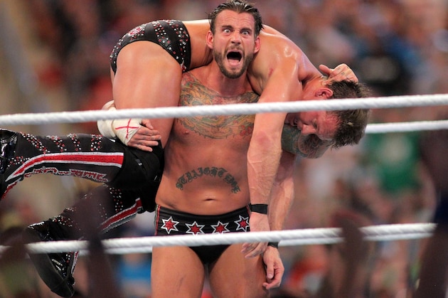 FILE - In this April 1, 2012, file photo, CM Punk competes against Chris Jericho at WrestleMania XXVIII in Sun Life Stadium in Miami Gardens, Fla. CM Punk making his debut as a mixed martial arts fighter on Saturday night in UFC 203. (AP Photo/AP Images for Wreslemania, Marc Serota, File)