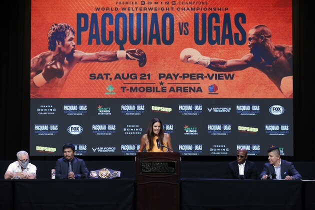 LAS VEGAS, NEVADA - AUGUST 18: Fox sports reporter Heidi Androl (C) hosts a news conference with Manny Pacquiao and WBA welterweight champion Yordenis Ugas at MGM Grand Hotel & Casino on August 18, 2021 in Las Vegas, Nevada. Seated from left: trainer Freddie Roach, Pacquiao, Ugas, and interpreter Ray Flores. Pacquiao will challenge Ugas for the title at MGM Grand Garden Arena on August 21 in Las Vegas. (Photo by Steve Marcus/Getty Images)