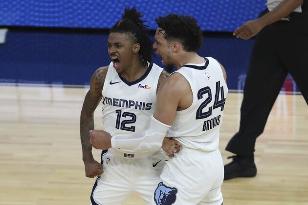 Memphis Grizzlies' Ja Morant, left, is congratulated by Dillon Brooks after scoring against the Golden State Warriors during overtime in an NBA basketball Western Conference play-in game in San Francisco, Friday, May 21, 2021. (AP Photo/Jed Jacobsohn)