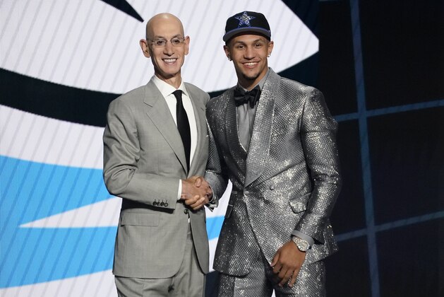 Jalen Suggs, right, poses for a photo with NBA Commissioner Adam Silver after being selected fifth overall by the Orlando Magic during the first round of the NBA basketball draft, Thursday, July 29, 2021, in New York. (AP Photo/Corey Sipkin)