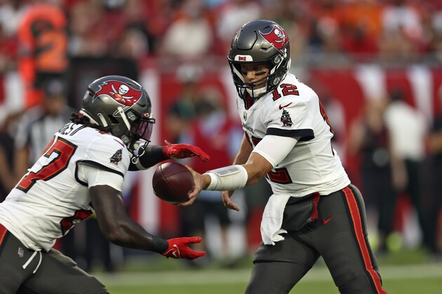 Tampa Bay Buccaneers quarterback Tom Brady (12) hands off to running back Ronald Jones (27) during the first half of an NFL preseason football game against the Cincinnati Bengals Saturday, Aug. 14, 2021, in Tampa, Fla. (AP Photo/Mark LoMoglio)