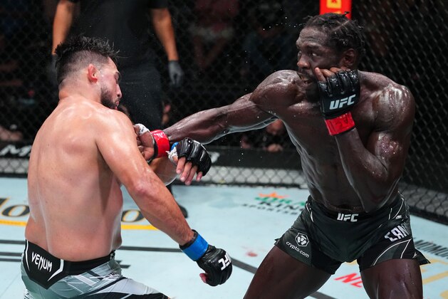 LAS VEGAS, NEVADA - AUGUST 21: (R-L) Jared Cannonier punches Kelvin Gastelum in a middleweight fight during the UFC Fight Night event at UFC APEX on August 21, 2021 in Las Vegas, Nevada. (Photo by Chris Unger/Zuffa LLC)