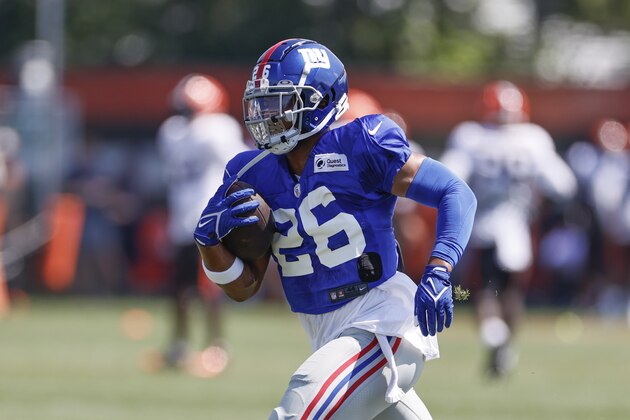 New York Giants running back Saquon Barkley (26) runs through a drill during a joint NFL football training camp practice with the Cleveland Browns Friday, Aug. 20, 2021, in Berea, Ohio. (AP Photo/Ron Schwane)