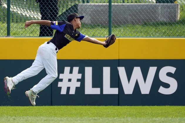 Torrance, Calif. right fielder Elias Emerson (21) catches a ball off the bat of Hamilton, Ohio's JJ Vogel (23) during the fourth inning of a baseball game at the Little League World Series in South Williamsport, Pa., Sunday, Aug. 22, 2021. (AP Photo/Tom E. Puskar)