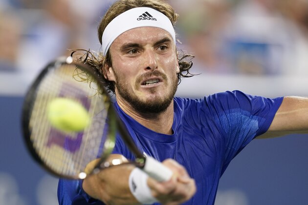 Stefanos Tsitsipas, of Greece, hits a forehand to Alexander Zverev, of Germany, during the Western & Southern Open tennis tournament Saturday, Aug. 21, 2021, in Mason, Ohio. (AP Photo/Darron Cummings)