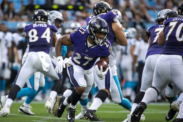 CHARLOTTE, NC - AUGUST 21: J.K. Dobbins #27 of the Baltimore Ravens runs the ball against the Carolina Panthers during the first half of a NFL preseason game at Bank of America Stadium on August 21, 2021 in Charlotte, North Carolina. (Photo by Chris Keane/Getty Images)