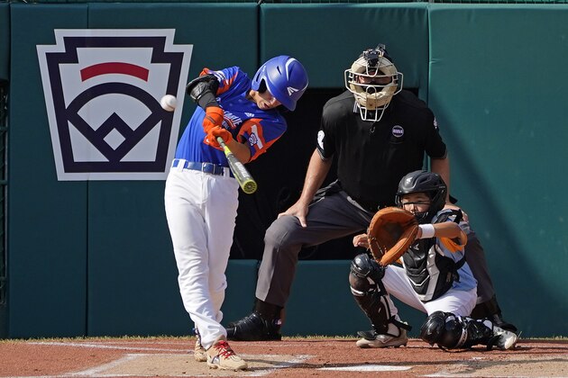 Taylor, Mich.'s Cameron Thorning, left, hits a two-run home run off Honolulu, Hawaii starting pitcher Micah Bennett during the first inning of a baseball game at the Little League World Series in South Williamsport, Pa., Saturday, Aug. 28, 2021. Catching is Hawaii's Chasen Uyetake and umpire is Brian Henry. (AP Photo/Tom E. Puskar)