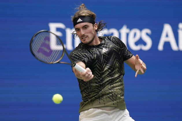 Stefanos Tsitsipas, of Greece, returns a shot to Andy Murray, of Great Britain, during the first round of the US Open tennis championships, Monday, Aug. 30, 2021, in New York. (AP Photo/Seth Wenig)