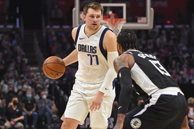 LOS ANGELES, CA - JUNE 6:  Luka Doncic #77 of the Dallas Mavericks handles the ball against Paul George #13 of the LA Clippers during Round 1, Game 7 of the 2021 NBA Playoffs on June 6, 2021 at STAPLES Center in Los Angeles, California. NOTE TO USER: User expressly acknowledges and agrees that, by downloading and/or using this Photograph, user is consenting to the terms and conditions of the Getty Images License Agreement. Mandatory Copyright Notice: Copyright 2021 NBAE (Photo by Juan Ocampo/NBAE via Getty Images)