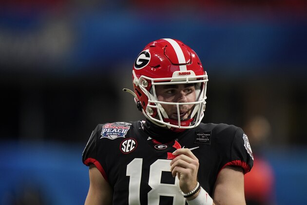 Georgia quarterback JT Daniels (18) walks the turf against Cincinnati during the first half of the Peach Bowl NCAA college football game, Friday, Jan. 1, 2021, in Atlanta. (AP Photo/Brynn Anderson)
