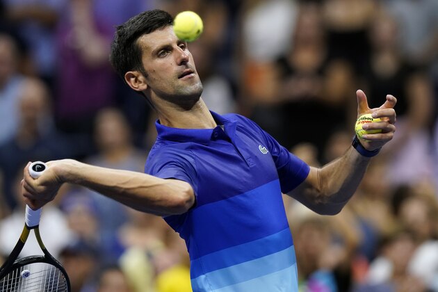 Novak Djokovic, of Serbia, hits balls into the stands after winning his first round at the US Open tennis championships, Tuesday, Aug. 31, 2021, in New York. (AP Photo/Frank Franklin II)