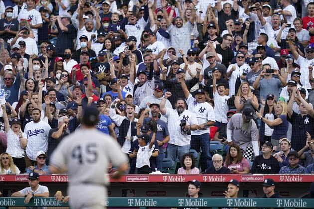 Fans cheer after New York Yankees starting pitcher Gerrit Cole strikes out Los Angeles Angels' Jared Walsh during the sixth inning of a baseball game Wednesday, Sep. 1, 2021, in Anaheim, Calif. (AP Photo/Ashley Landis)