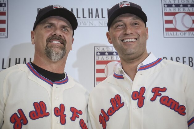 FILE - In this Jan. 22, 2020, file photo, New York Yankees shortstop Derek Jeter, right, and Colorado Rockies outfielder Larry Walker pose after receiving their Baseball Hall of Fame jerseys during a news conference in New York. (AP Photo/Bebeto Matthews, File)