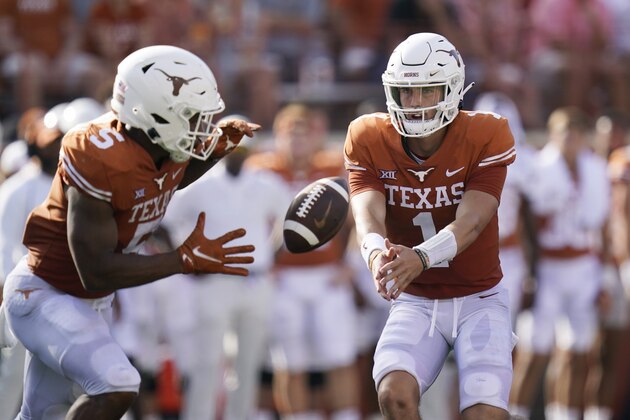 Texas quarterback Hudson Card (1) flips the ball to running back Bijan Robinson (5) during an NCAA college football game against the Louisiana-Lafayette, Tuesday, Sept. 7, 2021, in Austin, Texas. (AP Photo/Eric Gay)