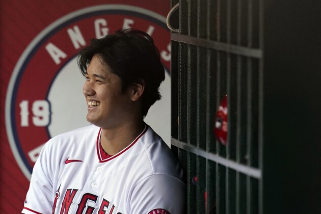 Los Angeles Angels' Shohei Ohtani smiles in the dugout during the first inning of a baseball game against the Texas Rangers Monday, Sept. 6, 2021, in Anaheim, Calif. (AP Photo/Marcio Jose Sanchez)