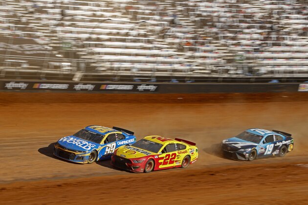 Driver Daniel Suarez (99) leads Joey Logano (22), and Martin Truex Jr. (19) during an NASCAR Cup Series auto race, Monday, March 29, 2021, in Bristol, Tenn. (AP Photo/Wade Payne)