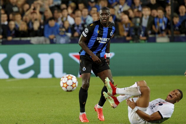 PSG's Kylian Mbappe, right, goes down as he fights for the ball during the Champions League Group A soccer match between Club Brugge and PSG at the Jan Breydel stadium in Bruges, Belgium, Wednesday, Sept. 15, 2021. (AP Photo/Olivier Matthys)