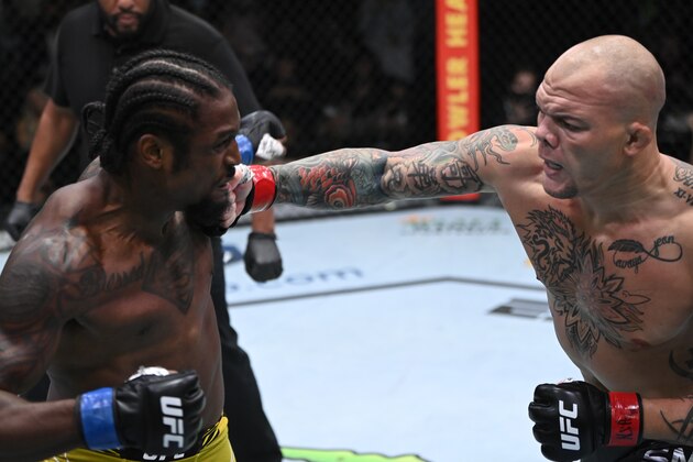LAS VEGAS, NEVADA - SEPTEMBER 18: (R-L) Anthony Smith punches Ryan Spann in a light heavyweight fight during the UFC Fight Night event at UFC APEX on September 18, 2021 in Las Vegas, Nevada. (Photo by Jeff Bottari/Zuffa LLC)