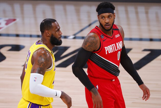 Los Angeles Lakers' LeBron James and Portland Trail Blazers' Carmelo Anthony look on during the first quarter in Game 2 of an NBA basketball first-round playoff series, Thursday, Aug. 20, 2020, in Lake Buena Vista, Fla. (Kevin C. Cox/Pool Photo via AP)
